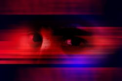 eyes of an anxious man covered in red and blue light