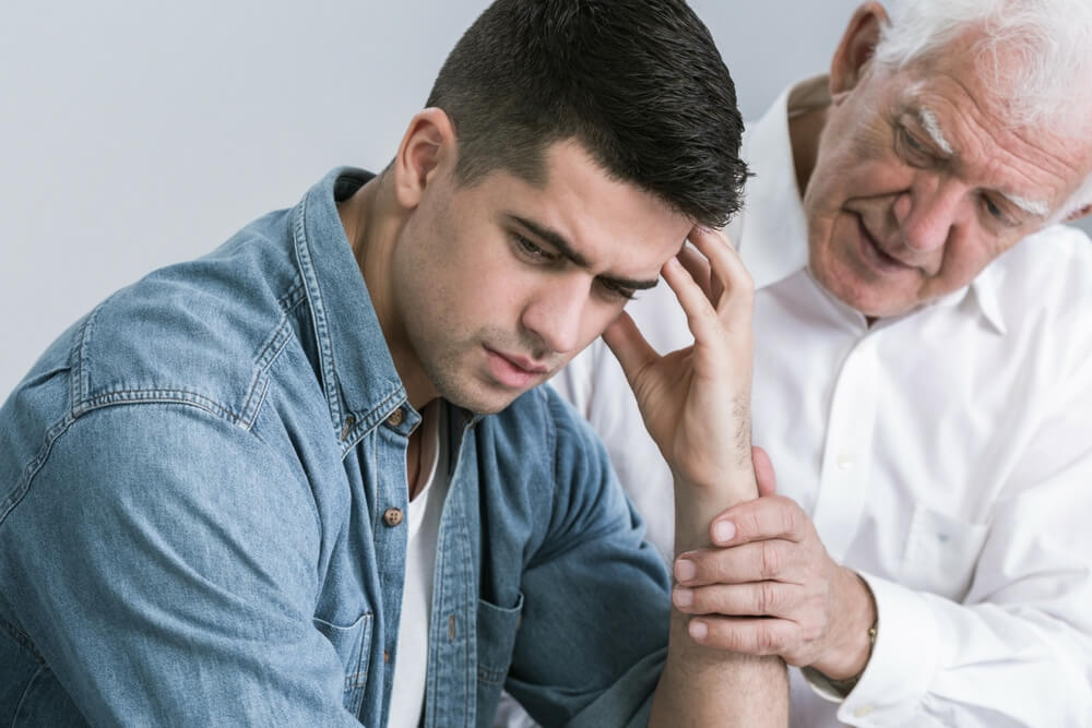lighthousetreatment-are-my-parents-responsible-for-my-addiction-article-photo-shot-of-an-elegant-man-trying-to-support-his-upset-son-469891088