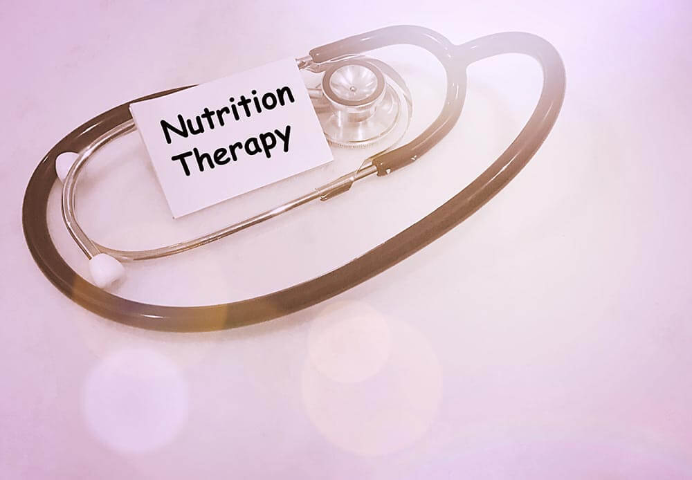 lighthousetreatment-importance-of-proper-nutrition-in-recovery-photo-nutrition-therapy-text-with-stethoscopes-pink-background-and-flare-559662067
