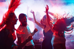 a group of partygoers in a club dancing 