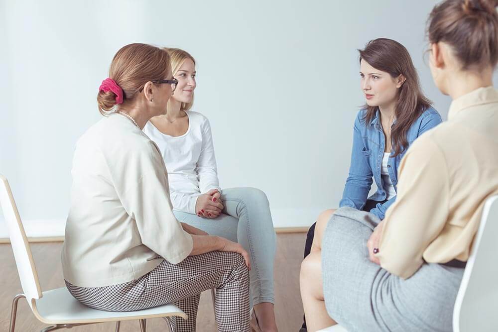 lighthousetreatment-how-to-deal-with-my-family-and-stay-sober-article-photo-people-discussing-something-during-support-group-meeting-380137942