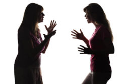 silhouette of two women arguing