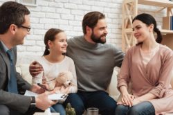 lighthousetreatment-families-need-support-too-article-photo-happy-family-of-three-talking-with-psychologist-family-psychotherapy-concept-visit-to-family