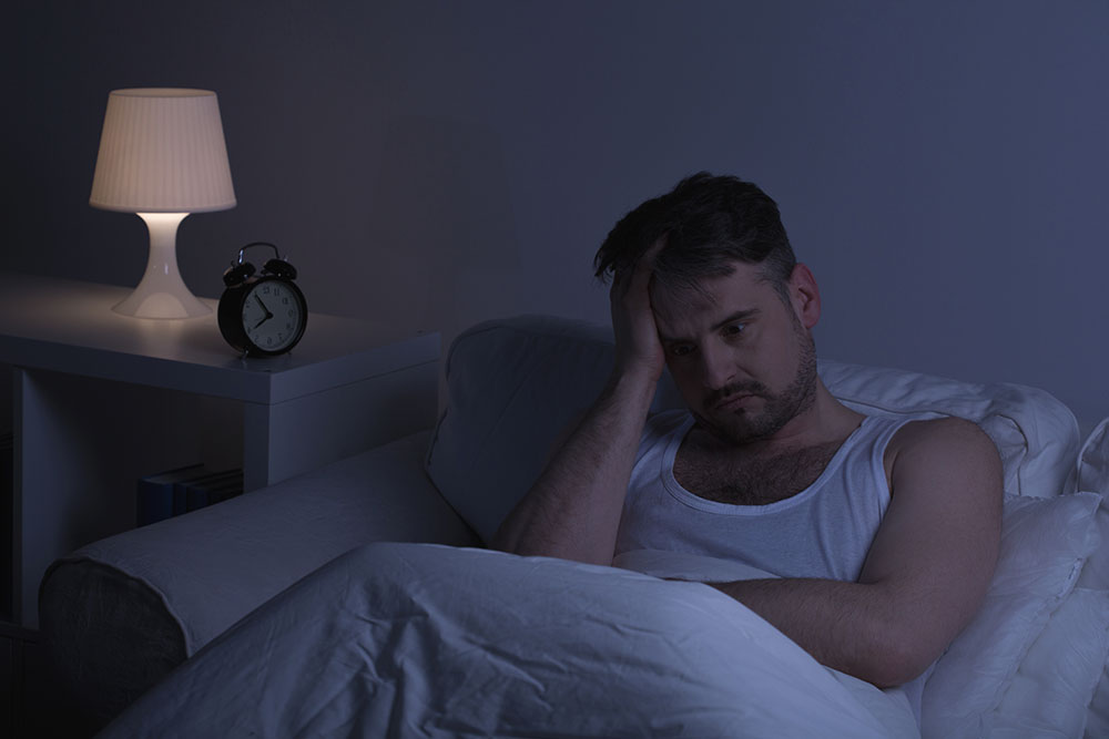 lighthousetreatment-what-is-ketamine-article-photo-man-suffering-from-sleeplessness-sitting-in-the-bed