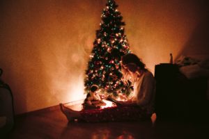 a woman reading a book bythe Christmas tree inside a drug rehab